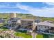 Expansive aerial view of homes, landscaped yards, and a scenic natural backdrop at 2125 S Orion St, Lakewood, CO 80228