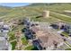 Aerial view of a neighborhood with a modern house and mountain views at 2125 S Orion St, Lakewood, CO 80228