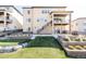 Stunning backyard with lush green space, stone terraces, and outdoor living areas at 2125 S Orion St, Lakewood, CO 80228