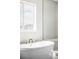 Elegant bathroom showcasing a freestanding tub next to a glass shower with mountain views from the window at 2125 S Orion St, Lakewood, CO 80228