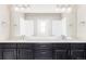 Stylish bathroom with dual sinks, dark cabinetry, and a well-lit vanity at 2125 S Orion St, Lakewood, CO 80228