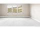 Spacious, sunlit bedroom featuring three large windows offering picturesque outdoor views at 2125 S Orion St, Lakewood, CO 80228