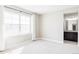 Bedroom featuring a large window with views and doorway leading to an en-suite bathroom at 2125 S Orion St, Lakewood, CO 80228