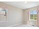 Bright and airy bedroom featuring two windows with soft pink curtains and scenic views at 2125 S Orion St, Lakewood, CO 80228