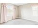 Bright, airy bedroom with soft pink accents and scenic views from the window at 2125 S Orion St, Lakewood, CO 80228