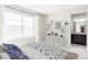 Comfortable bedroom with a large window, stylish furnishings, and a glimpse of an adjacent bathroom at 2125 S Orion St, Lakewood, CO 80228