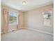 Spacious bedroom with neutral carpet, two windows with pink curtains and views of the hills at 2125 S Orion St, Lakewood, CO 80228