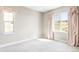 Bright, airy bedroom featuring a large window and plush carpeting at 2125 S Orion St, Lakewood, CO 80228