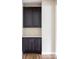 Chic built-in bar area with dark cabinets, stainless hardware, and light countertop at 2125 S Orion St, Lakewood, CO 80228