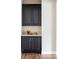 Butler's pantry featuring dark cabinets, quartz countertops and fruit at 2125 S Orion St, Lakewood, CO 80228