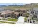 Aerial view of a two-story stucco home with tile roof, attached garage and long driveway at 2125 S Orion St, Lakewood, CO 80228