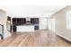 Open-concept kitchen featuring dark cabinets, stainless steel appliances, and a large island at 2125 S Orion St, Lakewood, CO 80228