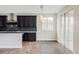 Kitchen featuring dark cabinets, stainless steel appliances, an island, and a dining area at 2125 S Orion St, Lakewood, CO 80228