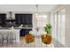 Kitchen featuring island seating, dark wood cabinets and stainless steel appliances at 2125 S Orion St, Lakewood, CO 80228