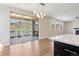 Bright living room with hardwood floors, sliding glass door, and mountain views at 2125 S Orion St, Lakewood, CO 80228