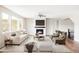 Bright living room with a marble fireplace, a ceiling fan, and large windows at 2125 S Orion St, Lakewood, CO 80228