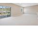 Large living room with sliding glass doors to a deck and a window with views of mountains at 2125 S Orion St, Lakewood, CO 80228