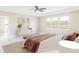This staged main bedroom is beautifully lit with views of the mountains at 2125 S Orion St, Lakewood, CO 80228