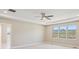 Sun-drenched main bedroom featuring three large windows with scenic views and a modern ceiling fan at 2125 S Orion St, Lakewood, CO 80228