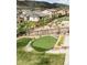 Landscaped putting green surrounded by rocks and lush foliage at 2125 S Orion St, Lakewood, CO 80228