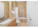 Bathroom featuring a sink with granite countertop, shower-tub combo with tile surround and decorative framed art at 402 Garfield St, Denver, CO 80206