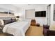 Contemporary bedroom with a sleek TV, luggage decor, and a cozy purple armchair at 402 Garfield St, Denver, CO 80206
