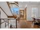 Light-filled entryway featuring modern staircase, wood floors, and designer mirror at 402 Garfield St, Denver, CO 80206