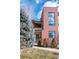 Contemporary brick home with large windows, a balcony, manicured landscaping, and welcoming front entry at 402 Garfield St, Denver, CO 80206