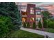 Beautiful two-story home featuring a well-manicured lawn and a brick facade at 402 Garfield St, Denver, CO 80206