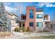 Modern home showcases a mix of brick and beige siding, a balcony, and manicured landscaping at 402 Garfield St, Denver, CO 80206