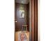 Narrow hallway with a door, stool, wood paneled walls and carpet at 402 Garfield St, Denver, CO 80206