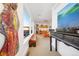 Bright hallway with eye-catching art, leading to a sunlit seating area with scenic views and a kitchenette at 402 Garfield St, Denver, CO 80206