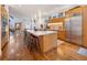 Spacious kitchen featuring a large island with marble countertop, stainless steel appliances, and wood cabinets at 402 Garfield St, Denver, CO 80206