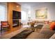 Bright living room with a fireplace, large sectional sofa, and an eye-catching decorative rug at 402 Garfield St, Denver, CO 80206