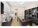 Well-lit office space with large desk, built-in shelving, and a view to the outdoors at 402 Garfield St, Denver, CO 80206