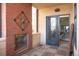 Covered outdoor patio with brick fireplace, wood floors, and view through door to bedroom at 402 Garfield St, Denver, CO 80206