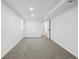 Carpeted basement bedroom offers an open doorway and natural light at 6894 Nelson St, Arvada, CO 80004