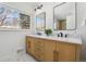 Bright bathroom featuring double sink vanity, modern mirrors, and stylish fixtures at 6894 Nelson St, Arvada, CO 80004