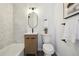 Modern bathroom features a sleek vanity, and a striking marble-look hexagon-tiled accent wall at 6894 Nelson St, Arvada, CO 80004