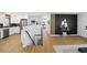 Inviting foyer with staircase, black accent wall, modern decor, and light wood flooring at 6894 Nelson St, Arvada, CO 80004