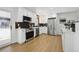 Stylish kitchen with white cabinets, stainless steel appliances, and modern black backsplash at 6894 Nelson St, Arvada, CO 80004