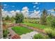 A beautiful backyard with manicured lawn, tasteful landscaping, and a charming wooden fence, perfect for relaxing outdoors at 21345 E 59Th Dr, Aurora, CO 80019