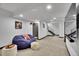 Basement with cozy beanbag, modern staircase, and neutral carpeting throughout at 21345 E 59Th Dr, Aurora, CO 80019