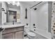 Modern bathroom featuring a vanity with gray cabinetry and a shower-tub combo at 21345 E 59Th Dr, Aurora, CO 80019
