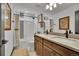 Inviting bathroom with dual vanities, white countertops, and tiled shower-tub combo at 21345 E 59Th Dr, Aurora, CO 80019