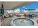 Relaxing deck with a hot tub, comfortable seating, and an umbrella for shade at 21345 E 59Th Dr, Aurora, CO 80019