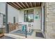 Inviting front porch with rocking chairs and a cozy outdoor rug, enhancing the home's curb appeal at 21345 E 59Th Dr, Aurora, CO 80019