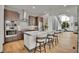 Contemporary kitchen featuring a large island, modern appliances, and adjacent living space, ideal for cooking and socializing at 21345 E 59Th Dr, Aurora, CO 80019