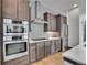 Kitchen with stainless steel appliances, gas range, and white backsplash at 21345 E 59Th Dr, Aurora, CO 80019