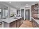 Modern kitchen featuring a central island with stainless steel appliances and wood flooring at 21345 E 59Th Dr, Aurora, CO 80019